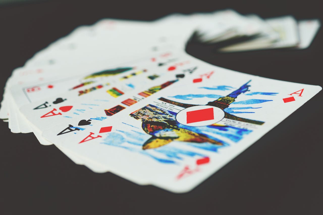 A visually striking close-up of a spread of playing cards showcasing colorful designs and aces.